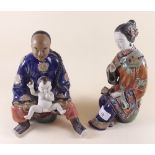 A pair of Japanese figures with man holding a baby and a woman 24cm