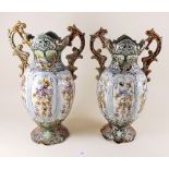 A pair of Majolica style two handled vases and a similar jug