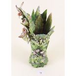 A Victorian porcelain vase of ornate fern and leaf form applied lily of the valley, cyclamen and