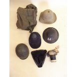 A group of military helmets, kit bag etc