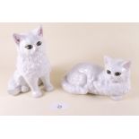 Two white china cats