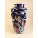 A Chinese vase painted birds and flowers on a blue ground