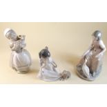 Three Nao figures including girl carrying lamb, girl with dog and lady with goose - 21cm