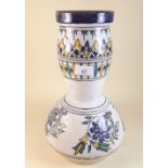 A Faience style vase decorated flowers in blue, white and yellow 35cm