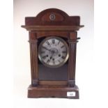 A late 19th century architectural alarm mantel clock with bell to top of case