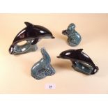 Two Poole Pottery dolphins, an otter and a seal