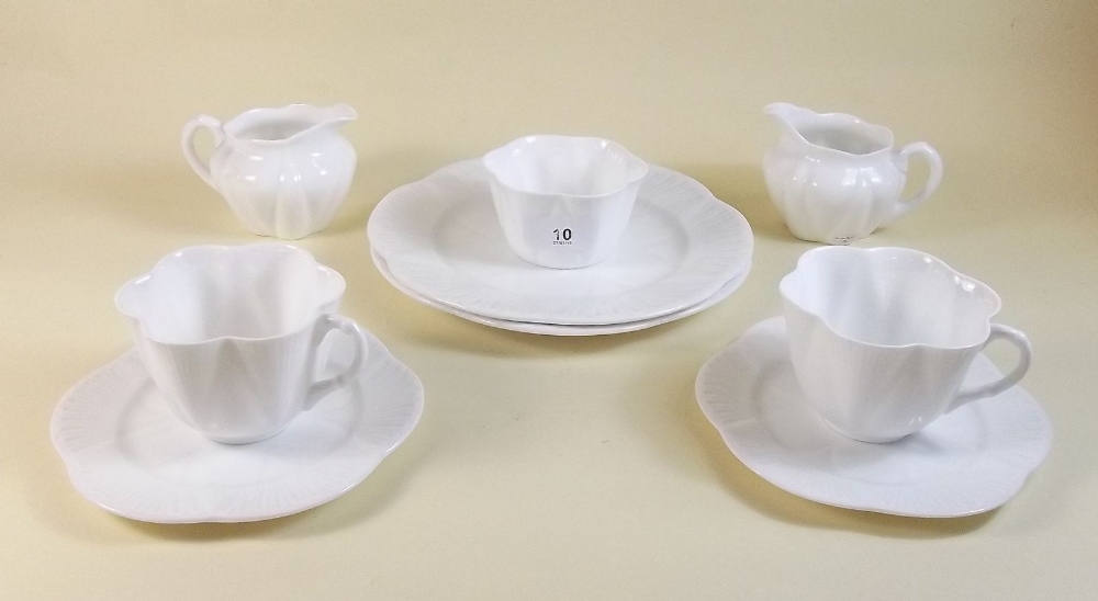 A Shelley white moulded tea service comprising: ten cups and twelve saucers, twelve tea plates, cake