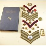 A group of cap badges, buttons, buckles etc, plus a History of the Divisional Engineers