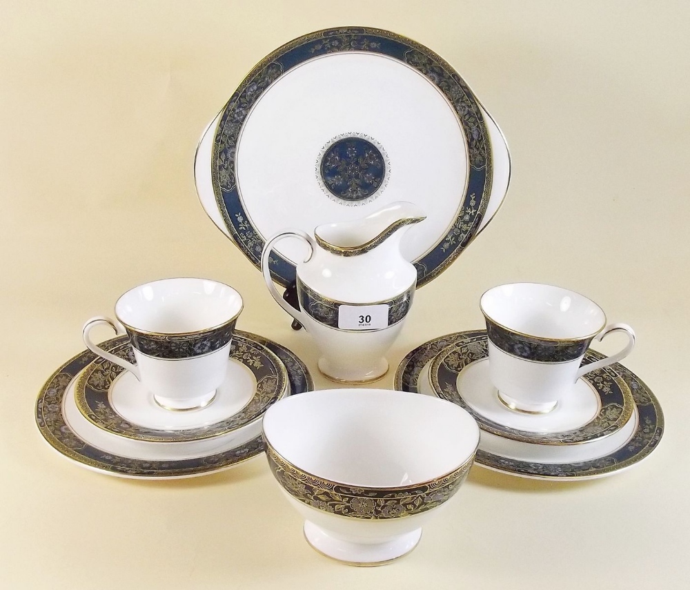 A Royal Doulton Carlyle tea service comprising six cups and saucers, cake plate, six tea plates,