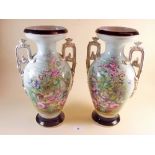 A pair of large Victorian two handled floral painted vases, 37cm tall