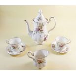 A Royal Albert Moss Rose coffee pot, six coffee cups and saucers and cream jug