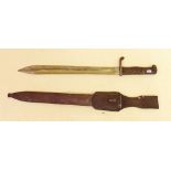 A German WWI bayonet in metal scabbard with leather frog