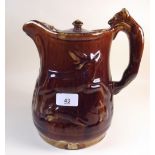 A large Victorian treacle glazed jug, moulded animals