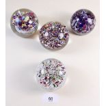 Four various splattered glass paperweights