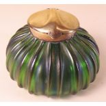 An Art Nouveau lustred glass inkwell with brass lid