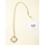 An 18 carat gold baroque pearl pendant on 9 carat gold chain
