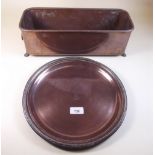 A circular copper tray and a small copper planter