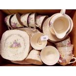 An H & K 1930's tea service decorated garden scene comprising ten cups and saucers, twelve tea