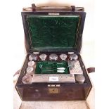 A Victorian rosewood toiletry box with leather travelling case, fitted contents of glass and