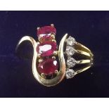 A 14 carat gold asymetrical ruby and diamond ring - size 0