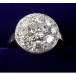 A platinum set diamond cluster ring with eight stone surround