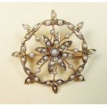 A 9 carat gold Edwardian circular brooch set seed pearls