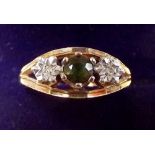 A 9 carat gold diamond and emerald ring