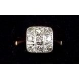 An 18 carat gold ring set square panel of nine diamonds - size O/P