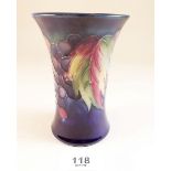 A Moorcroft waisted vase painted leaves and berries on a blue ground - 11cm