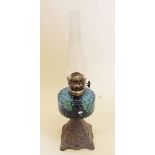 A Victorian oil lamp with blue glass reservoir