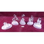 Five large glass paperweights in the form of various animals: dolphin, squirrel, dogs, owl, horse