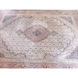 A large good quality Persian style carpet with medallion design on a cream ground 339 x 251cm