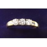 An 18 carat three stone diamond ring - size O