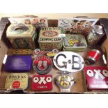 A box of vintage tins and packaging, plus two AA badges