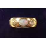 A 22 carat gold ring with engraved decoration and set opal - size L
