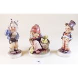 Three large Goebel figures:- girls with chicks, boy singing and boy with bandaged head