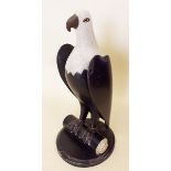 An American Folk Art style painted resin eagle - a/f, on wooden stand