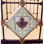 A Victorian brass and iron double bedhead and end inset Victorian Majolica tile, with pair or irons