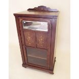 An Edwardian mahogany and marquetry single door music cabinet