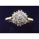 A gold and diamond set cluster ring - size S