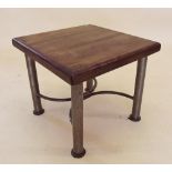 A hardwood occasional table with hammered metal legs and curved stretchers, by RK