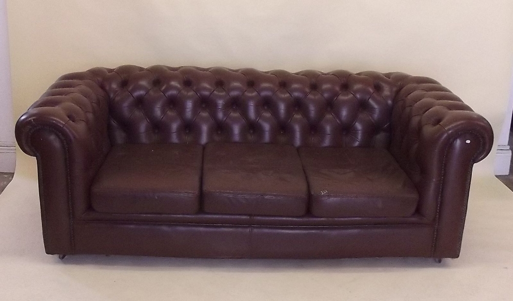 A brown leather Chesterfield sofa