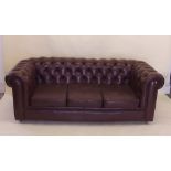 A brown leather Chesterfield sofa