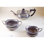 A silver three piece tea service with half gadrooned decoration by Cooper Bros and Sons, Sheffield