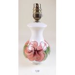 A Moorcroft table lamp painted peach hibiscus on a cream ground - 23cm