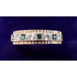 A 9 carat gold emerald and white stone eternity ring - size N