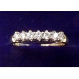 An 18 carat gold seven stone diamond ring - size M