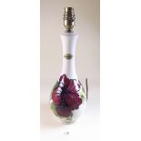 A Moorcroft table lamp painted red hibiscus on a cream ground - 34cm