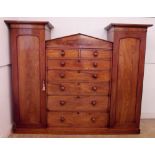 A Victorian large mahogany compactum wardrobe with two single doors flanking five long and two short
