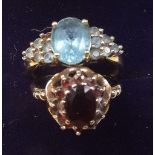 A 9 carat gold garnet cluster ring, size K and a 9 carat gold ring set blue topaz, size 0 (one stone